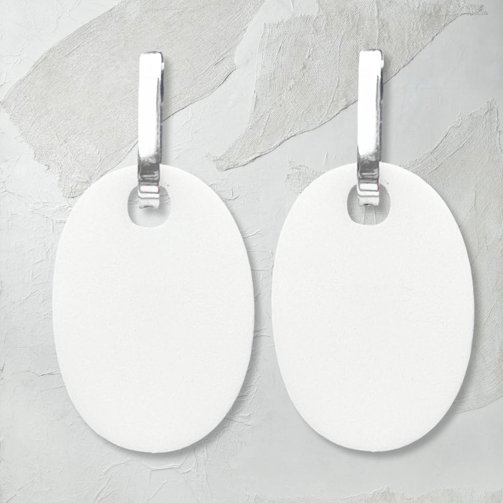 reversible white/black perspex earrings, white side. Frank Ideas
