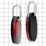 Close-up of gloss red and black tartan Perspex oval huggie earring by Frank Ideas