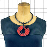 Perspex O necklace in red and black tartan worn as a statement piece by Frank Ideas