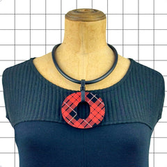 Perspex O necklace in red and black tartan worn as a statement piece by Frank Ideas