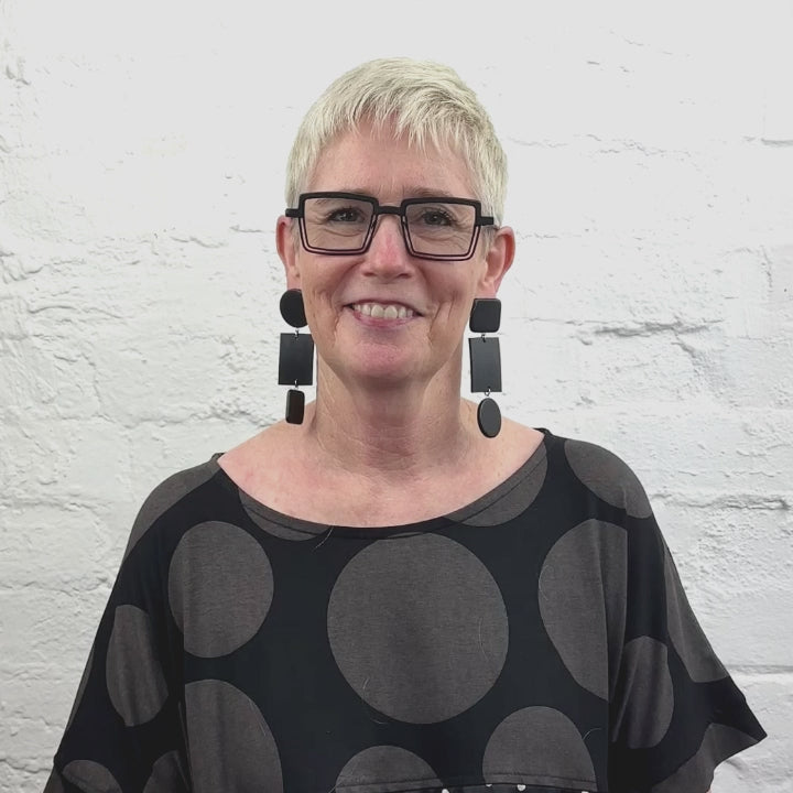 Video of rowan owner of Frank Ideas wearing drop black earrings