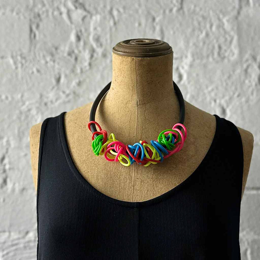 rainbow tangled necklace on a mannequin