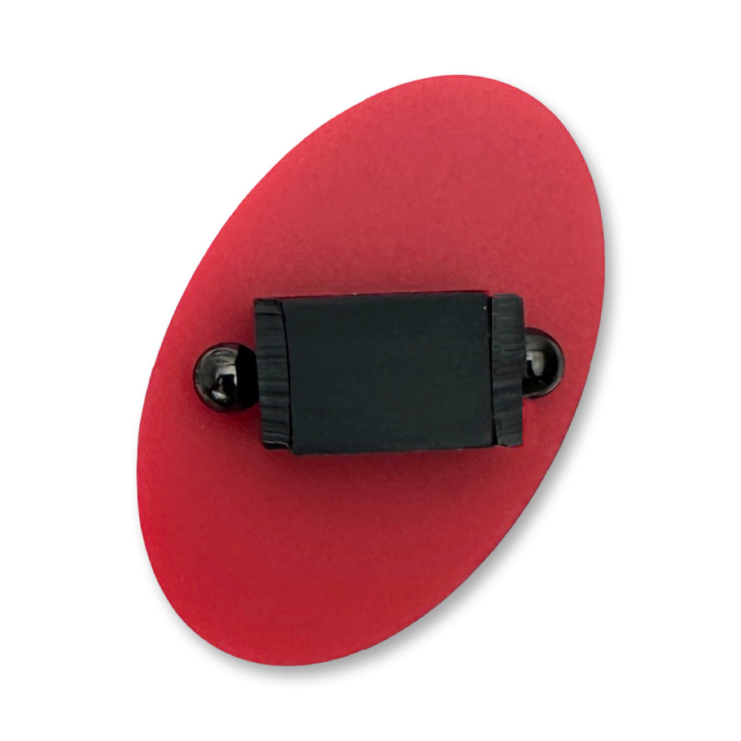 Red oval shaped ring with black centre on a white background