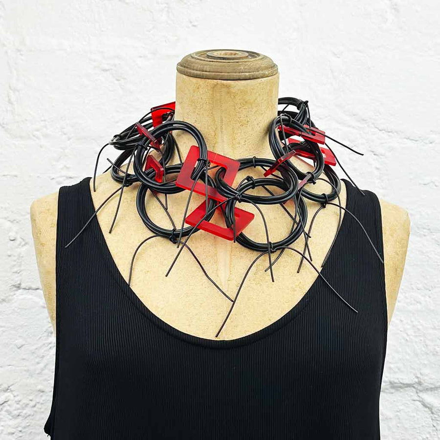 Long chaotic necklace recycled materials with red squares and black rubber o rings