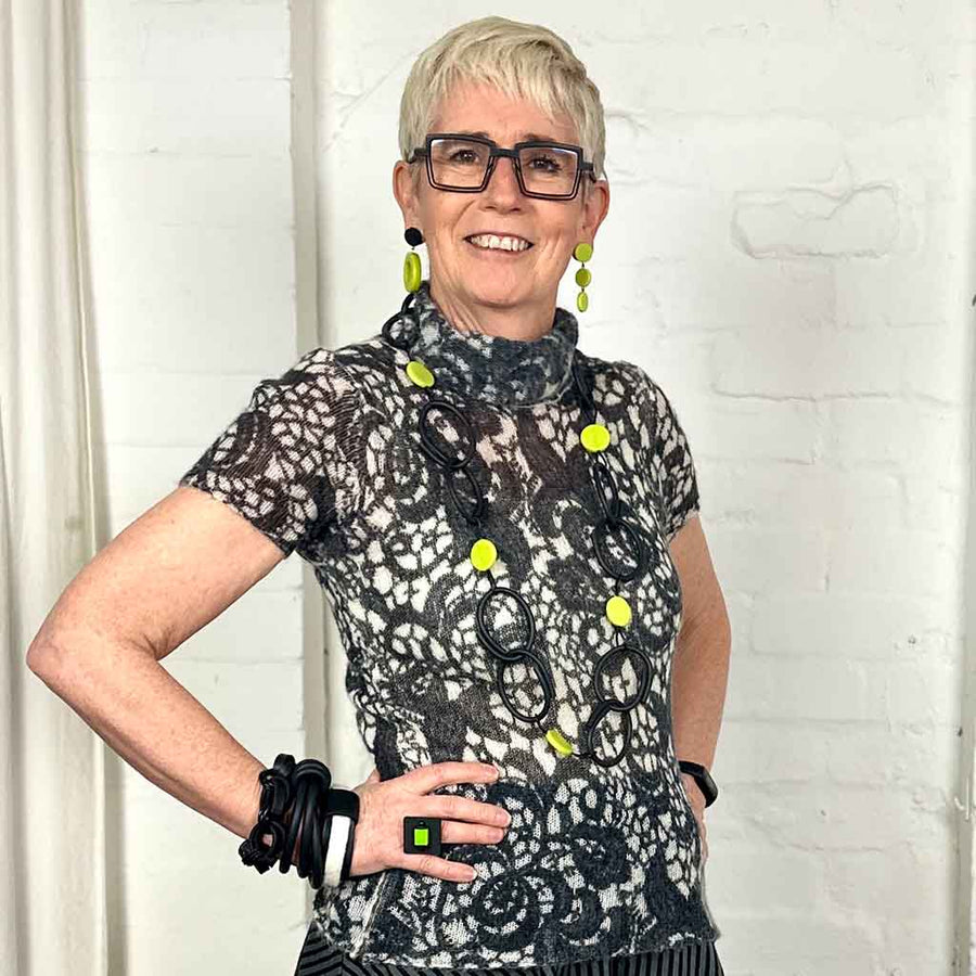 Rowan owner of Frank Ideas. Modelling is wearing yellow and black resin and rubber long chain necklace black with yellow dots.