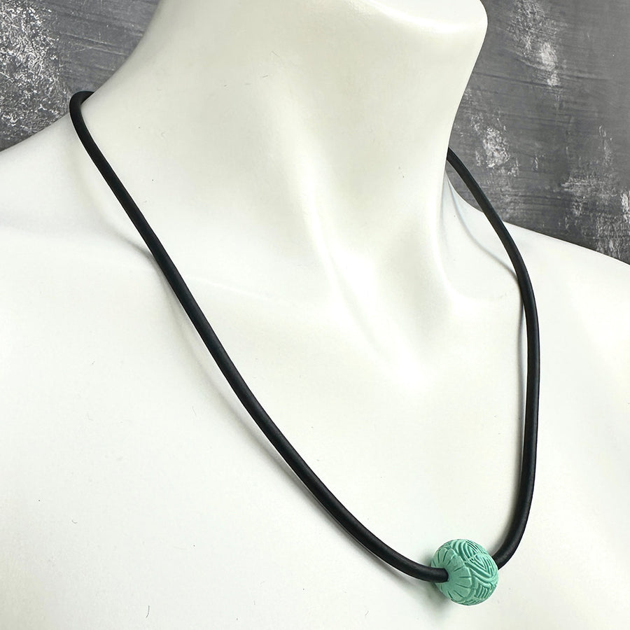 short single bead and thin rubber necklace -soft teal, patterned bead