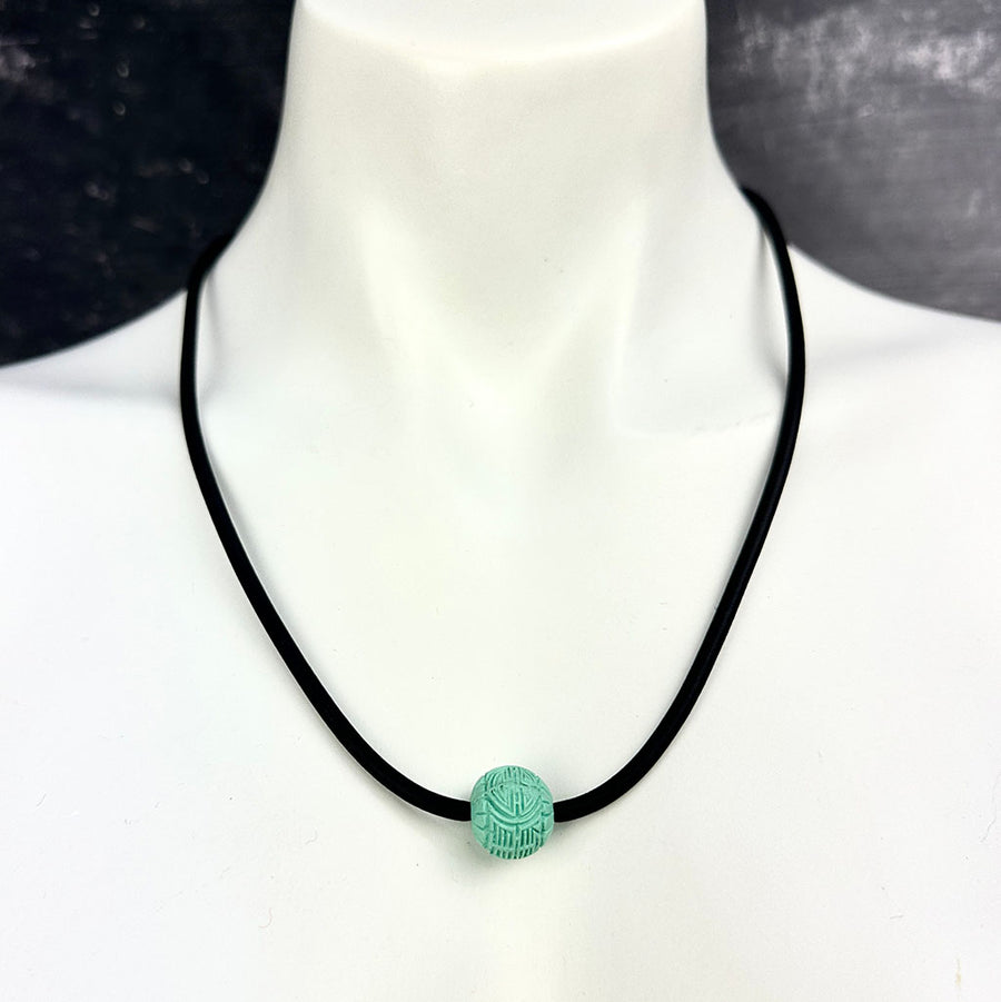 short single bead and thin rubber necklace -soft teal, patterned bead