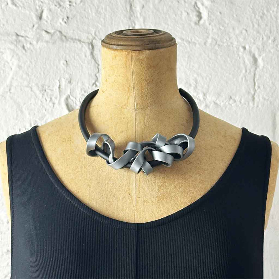 silver rubber tangled necklace on a mannequin