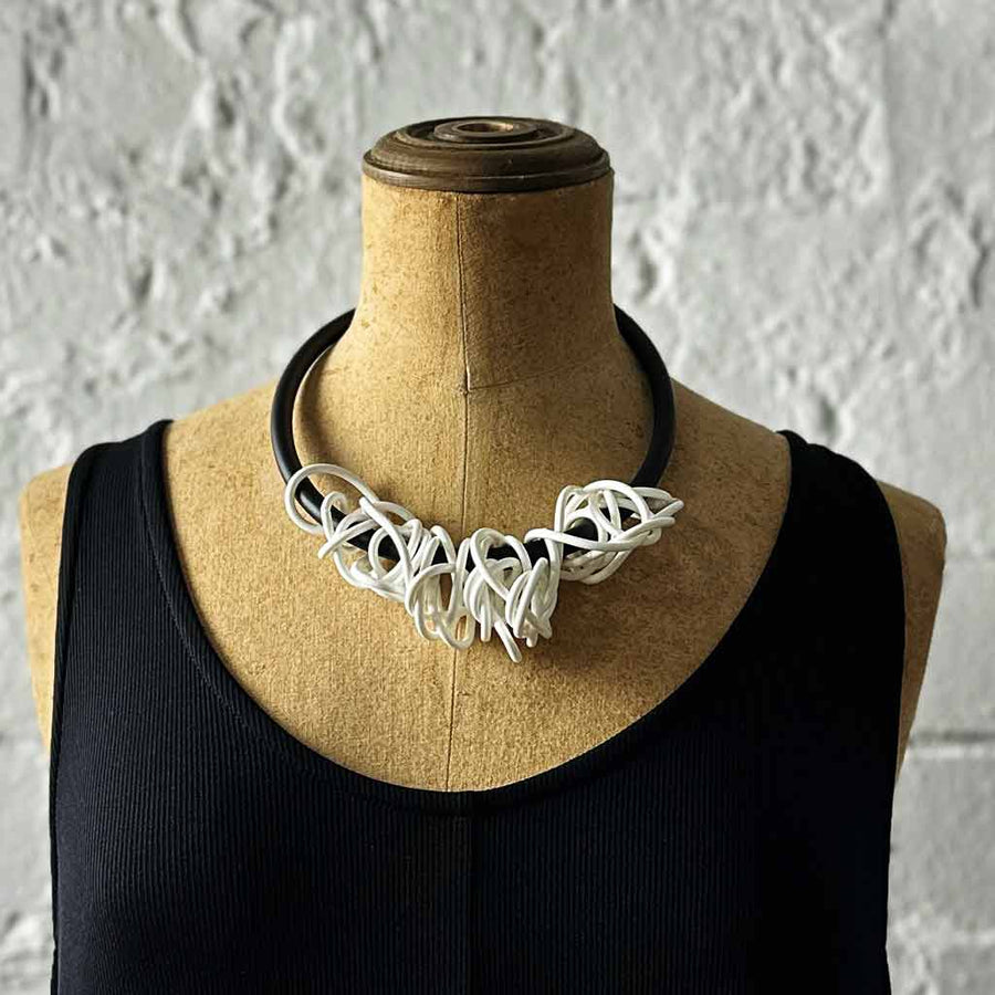 white tangled necklace on a mannequin