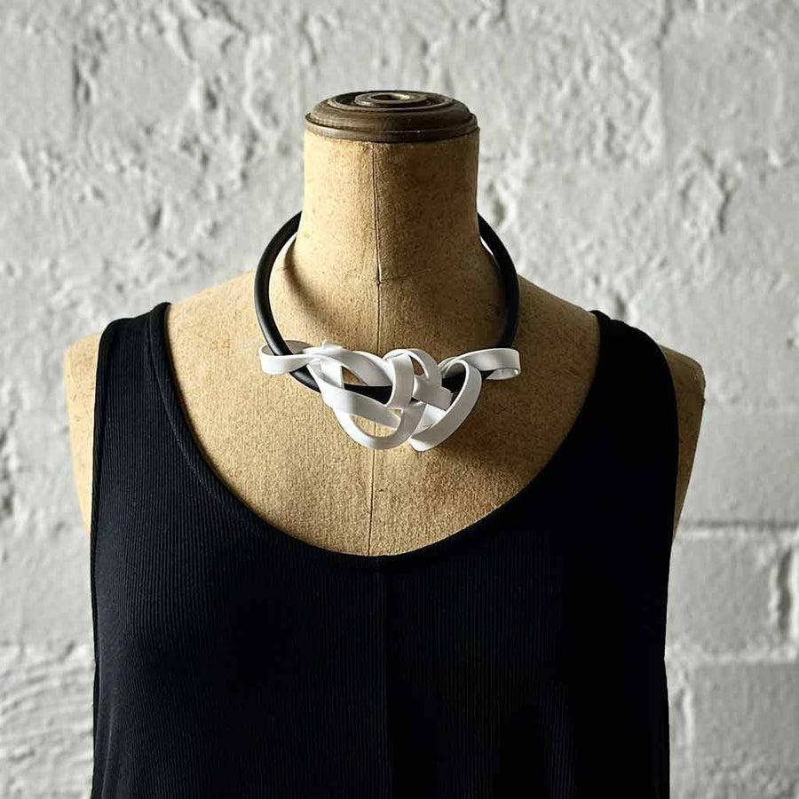 white rubber tangled necklace on a mannequin