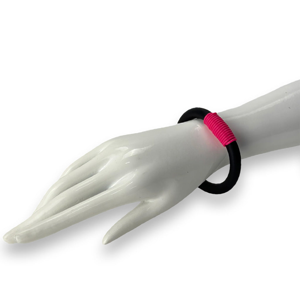 black and pink rubber bangle on a white background