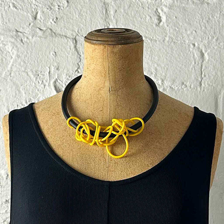 yellow tangled necklace on a mannequin