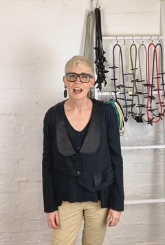 australian jewellery designer Rowan Shaw standing in front of her rubber jewellery necklaces