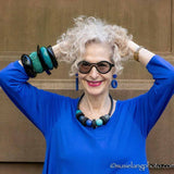 Dayle from Artfulcitystyle wearing blue resin miss matched earrings