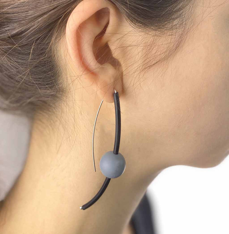 model-wearing-rubber-drop-earrings-grey