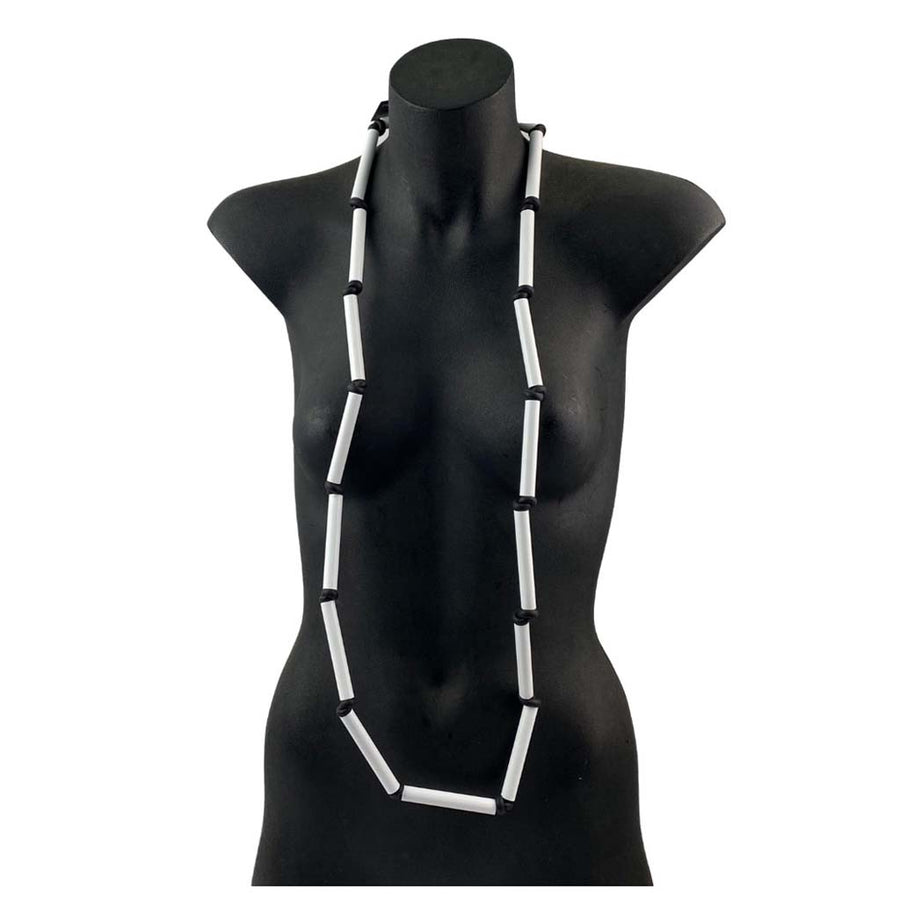 long black and white rod necklace on a torso mannequin