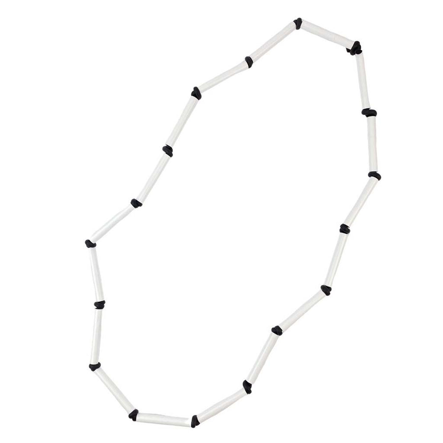 black and white rod necklace on a white background
