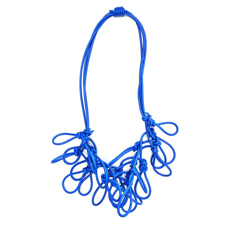 blue statement rubber necklace on a white background
