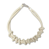 white/cream twist necklace on a white background