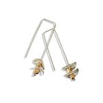silver earrings with round silver disks on a white background