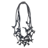 black knotted rubber necklace on a white background