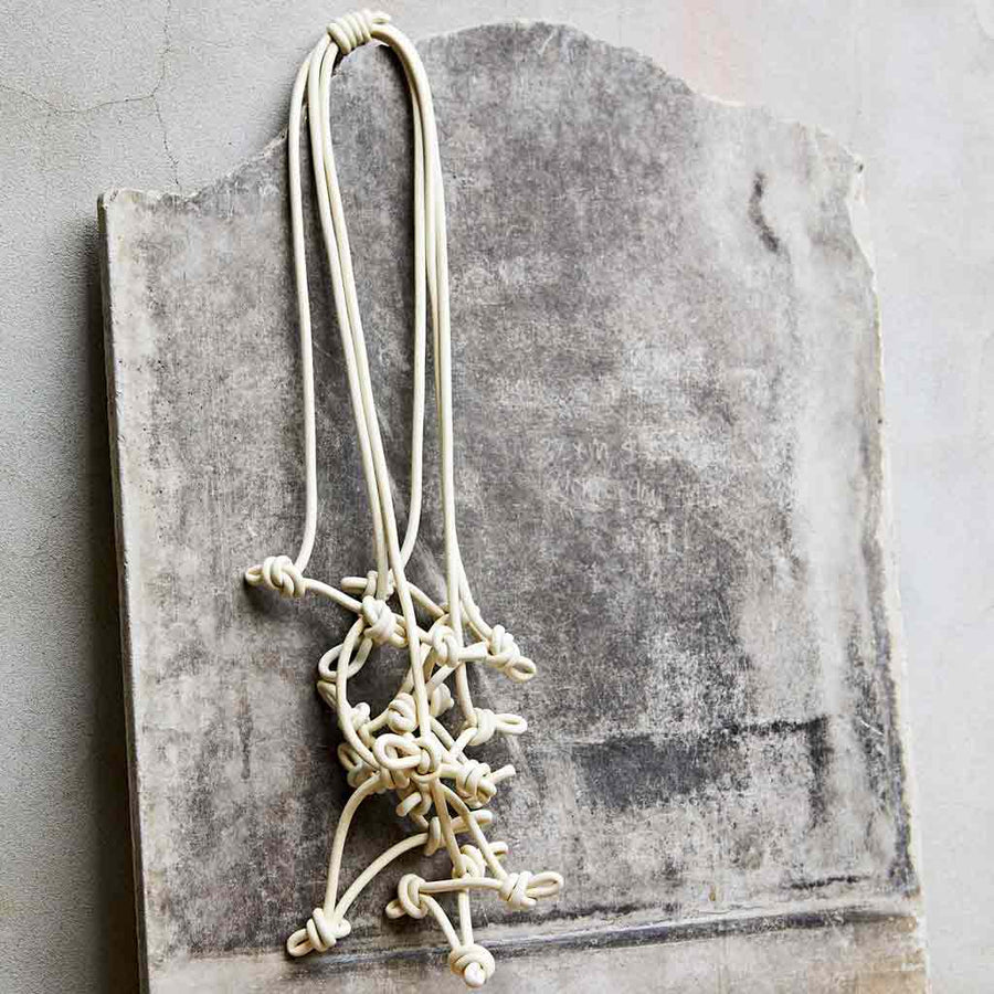 cream necklace on stone background prop