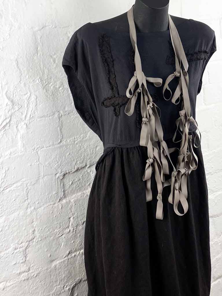 dusty-brown long boho rubber necklace on a mannequin