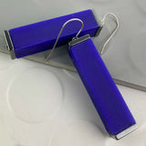 blue tower earrings on a white and grey backdrop 